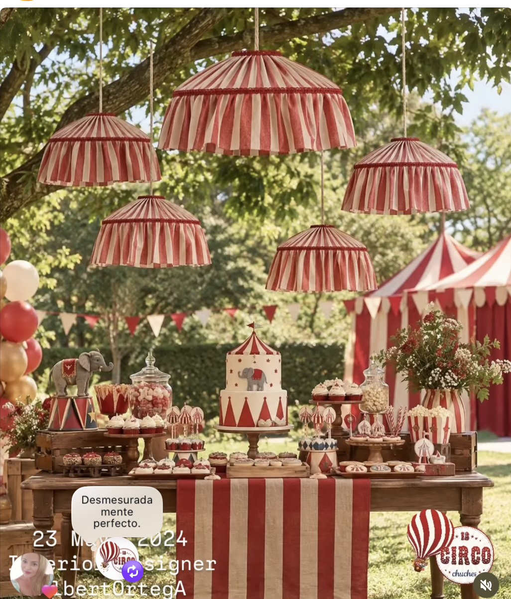 Mesa dulce al aire libre con lámparas y decoración circense roja y blanca